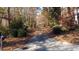 Gated driveway leads to a private property surrounded by lush trees at 3212 Woodhaven Sw Ct, Conyers, GA 30094
