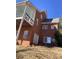 Brick home featuring a walkout basement, second-story deck, and multiple windows providing natural light at 3212 Woodhaven Sw Ct, Conyers, GA 30094