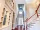 Beautiful foyer with high ceilings, cherry wood floors, staircase, and a custom-built shelving unit at 3212 Woodhaven Sw Ct, Conyers, GA 30094