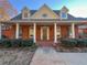 Charming brick home featuring a covered front porch with stately columns and dormer windows at 3212 Woodhaven Sw Ct, Conyers, GA 30094