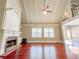 Bright living room with hardwood floors, a brick fireplace, and large windows with natural light at 3212 Woodhaven Sw Ct, Conyers, GA 30094