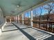 Covered porch with wooden railings, ceiling fans, and a view of the wooded landscape at 3212 Woodhaven Sw Ct, Conyers, GA 30094