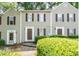Inviting townhome featuring neutral siding, dark shutters, and manicured shrubs at 3407 Spring Harbour Dr # 2, Doraville, GA 30340