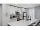Modern kitchen with stainless steel appliances, white cabinets, and a large island at 3407 Spring Harbour Dr # 2, Doraville, GA 30340