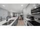 Open kitchen with stainless steel appliances and quartz countertops flows into the living room at 3407 Spring Harbour Dr # 2, Doraville, GA 30340