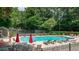 Community pool surrounded by lounge chairs and mature trees, perfect for relaxation at 3407 Spring Harbour Dr # 2, Doraville, GA 30340