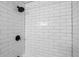 Modern bathroom shower featuring black hardware and white subway tile at 3407 Spring Harbour Dr # 2, Doraville, GA 30340