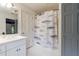 Clean bathroom featuring a single sink vanity and a shower with a fish shower curtain at 4500 Candacraig, Alpharetta, GA 30022