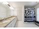 Bathroom with granite countertop, double sinks, and shower with privacy curtain at 4500 Candacraig, Alpharetta, GA 30022