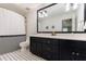 Stylish bathroom with black cabinets, dual sinks, and a modern black and white design at 4500 Candacraig, Alpharetta, GA 30022
