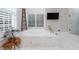 Luxurious bathroom featuring a soaking tub with marble surround, decorative ladder, and bright natural light at 4500 Candacraig, Alpharetta, GA 30022