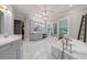 Elegant bathroom with a soaking tub, marble floors, light gray cabinetry and a decorative ladder at 4500 Candacraig, Alpharetta, GA 30022
