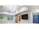 Bonus room with a sliding barn door, large TV, and a view of the lush greenery outside at 4500 Candacraig, Alpharetta, GA 30022