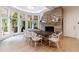 Dining room with brick fireplace, white wicker chairs, large windowed doors to backyard at 4500 Candacraig, Alpharetta, GA 30022