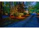 Stone driveway leading to a stately home, beautifully illuminated by landscape lighting at dusk at 4500 Candacraig, Alpharetta, GA 30022