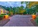 Beautiful brick driveway and entrance, with brick pillars, landscaped greenery, and classic statues adding elegance to this estate at 4500 Candacraig, Alpharetta, GA 30022
