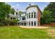 Back exterior featuring large windows, and manicured lawn, creating an inviting outdoor oasis at 4500 Candacraig, Alpharetta, GA 30022