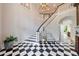 Elegant foyer with black and white flooring and grand staircase at 4500 Candacraig, Alpharetta, GA 30022