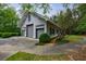 Side view of detached garage with lush landscaping at 4500 Candacraig, Alpharetta, GA 30022