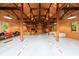 Spacious interior of detached garage with exposed wooden beams and ample space for storage and activities at 4500 Candacraig, Alpharetta, GA 30022