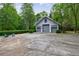 Exterior of detached garage with multiple bays, spacious parking, and lush landscaping at 4500 Candacraig, Alpharetta, GA 30022