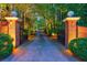 Scenic gated entrance at twilight, showcasing a private driveway framed by manicured landscaping and mature trees at 4500 Candacraig, Alpharetta, GA 30022