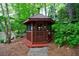 Secluded gazebo in a lush, wooded setting near the water's edge, perfect for relaxation at 4500 Candacraig, Alpharetta, GA 30022