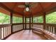 Interior view of the gazebo with a ceiling fan, bench seating, and serene views of the surrounding greenery at 4500 Candacraig, Alpharetta, GA 30022