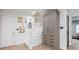 Hallway with stairway and display cabinet, painted in neutral colors with natural light at 4500 Candacraig, Alpharetta, GA 30022