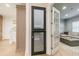 Hallway with view of pet suite, gray cabinetry, and doorway to the living room with comfortable seating at 4500 Candacraig, Alpharetta, GA 30022