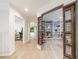 Hallway with hardwood floors, custom doors, and access to built-in shelving at 4500 Candacraig, Alpharetta, GA 30022