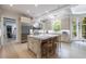 Bright open kitchen boasts a marble island, high-end appliances, and sun-lit breakfast nook at 4500 Candacraig, Alpharetta, GA 30022