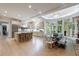Spacious kitchen and dining room with island seating, stone countertops, and light hardwood floors at 4500 Candacraig, Alpharetta, GA 30022
