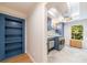 Laundry room with bright cabinetry, shelving, modern appliances, and natural light at 4500 Candacraig, Alpharetta, GA 30022