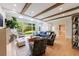 Bright living room featuring hardwood floors, a large window view, skylights, and wooden ceiling beams at 4500 Candacraig, Alpharetta, GA 30022