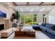 Bright living room with wooden beams, large windows, and comfortable seating at 4500 Candacraig, Alpharetta, GA 30022