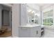 Main bathroom vanity with custom cabinets, modern fixtures, and natural light at 4500 Candacraig, Alpharetta, GA 30022