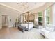 Spacious main bedroom with a four-poster bed, sitting area, and recessed lighting at 4500 Candacraig, Alpharetta, GA 30022