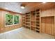 Cozy office space with wood paneling, built-in shelving, and a view of the trees outside at 4500 Candacraig, Alpharetta, GA 30022