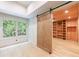 Light-filled office space with a barn door, built-in shelving, and a bright window at 4500 Candacraig, Alpharetta, GA 30022