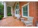 Inviting brick porch with seating area and elegant architectural details at 4500 Candacraig, Alpharetta, GA 30022