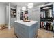 Well-organized walk-in closet with center island, custom shelving, and ample storage at 4500 Candacraig, Alpharetta, GA 30022