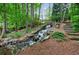 Backyard waterfall with stone steps and beautiful woodland setting at 4500 Candacraig, Alpharetta, GA 30022
