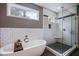 Elegant bathroom showcasing a freestanding tub and a shower with white tile surround at 1740 Bouldercrest Se Rd, Atlanta, GA 30316
