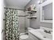Well-lit bathroom with a shower-tub combo and decorative shelves offers a practical and aesthetically pleasing space at 1740 Bouldercrest Se Rd, Atlanta, GA 30316