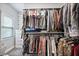 Organized walk-in closet with shelving, hanging rods, carpet flooring, and a window for natural light at 1740 Bouldercrest Se Rd, Atlanta, GA 30316