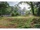 Two-story home surrounded by mature trees and lush greenery on a grassy lot at 1740 Bouldercrest Se Rd, Atlanta, GA 30316