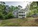 Back of the house with a large backyard and a two-story screened-in porch overlooking the yard at 1740 Bouldercrest Se Rd, Atlanta, GA 30316