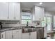 Modern kitchen with stainless steel appliances, farmhouse sink, and bright white cabinetry at 1740 Bouldercrest Se Rd, Atlanta, GA 30316