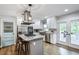 Modern kitchen with stainless appliances, island with seating, and access to the outdoor deck at 1740 Bouldercrest Se Rd, Atlanta, GA 30316